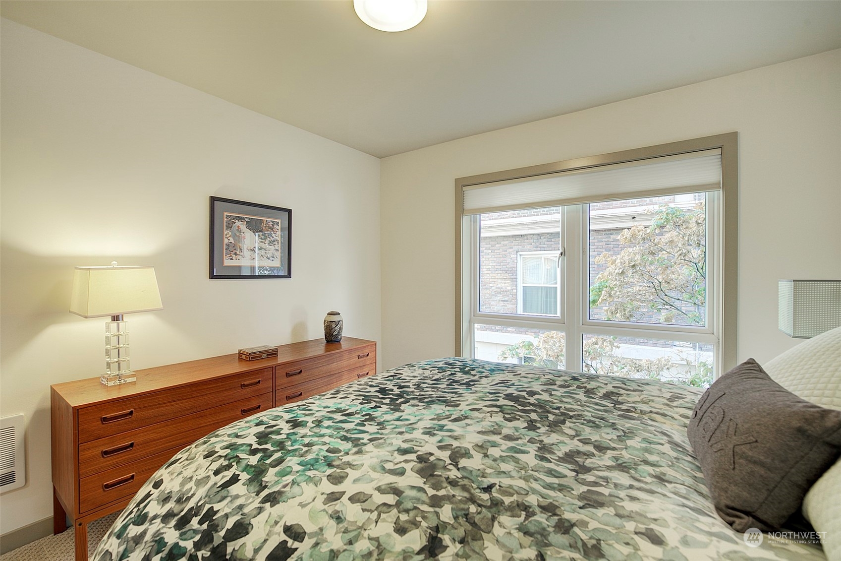 The oversized window in the bedroom is just like the big living room window, opening two different ways to welcome breezes. The custom window shade is brand new.