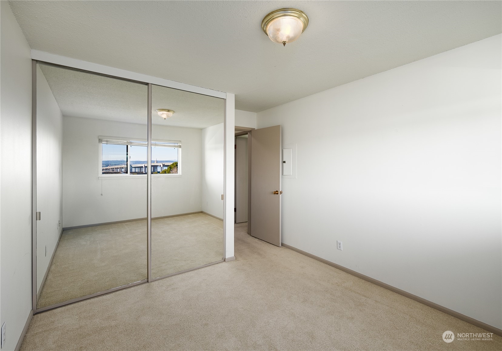 Mirrored closet doors in primary bedroom