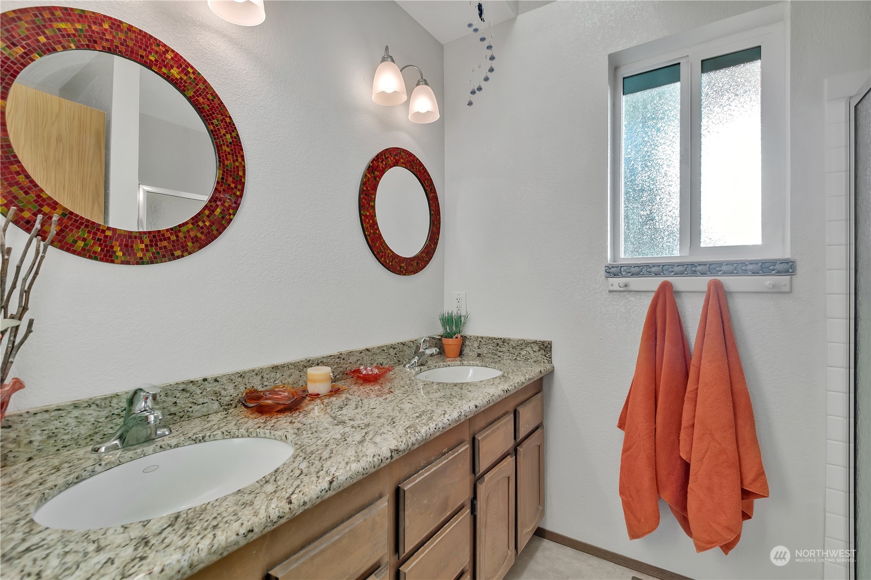 Double sinks in the primary bath and solid surface countertops...