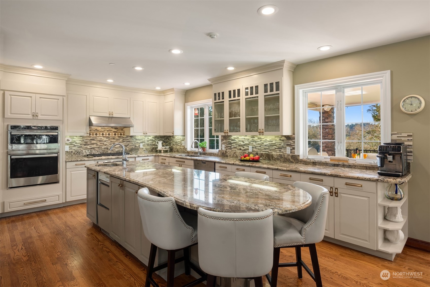 Chef's kitchen with granite island, professional appliances and walk-in pantry.