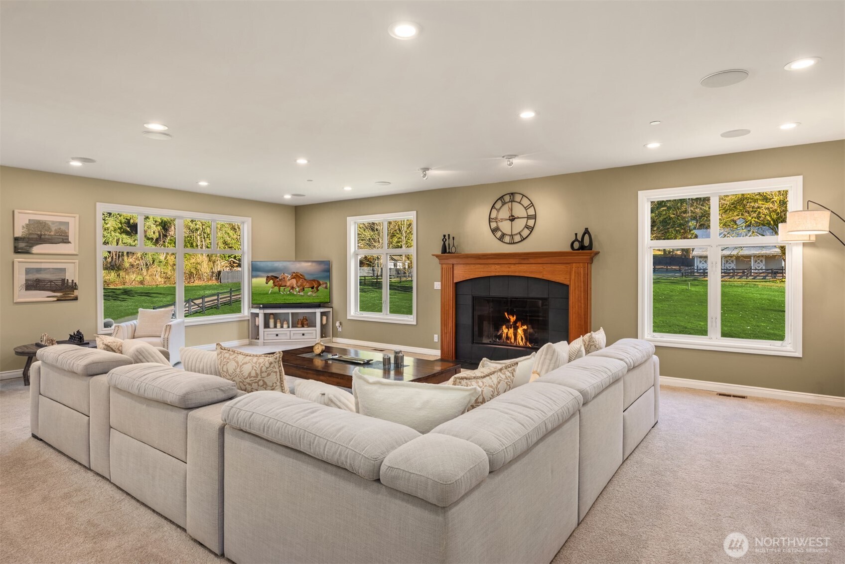 Grand living room with walls of windows and natural light.