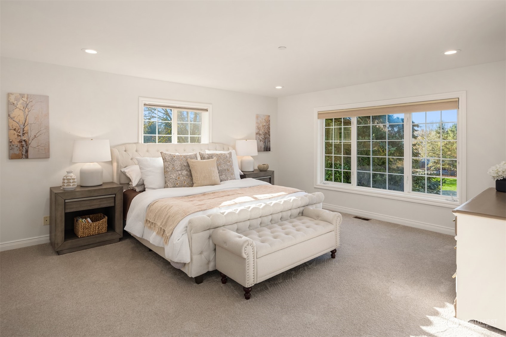 Light & bright primary bedroom with dual walk-in dressing suites.