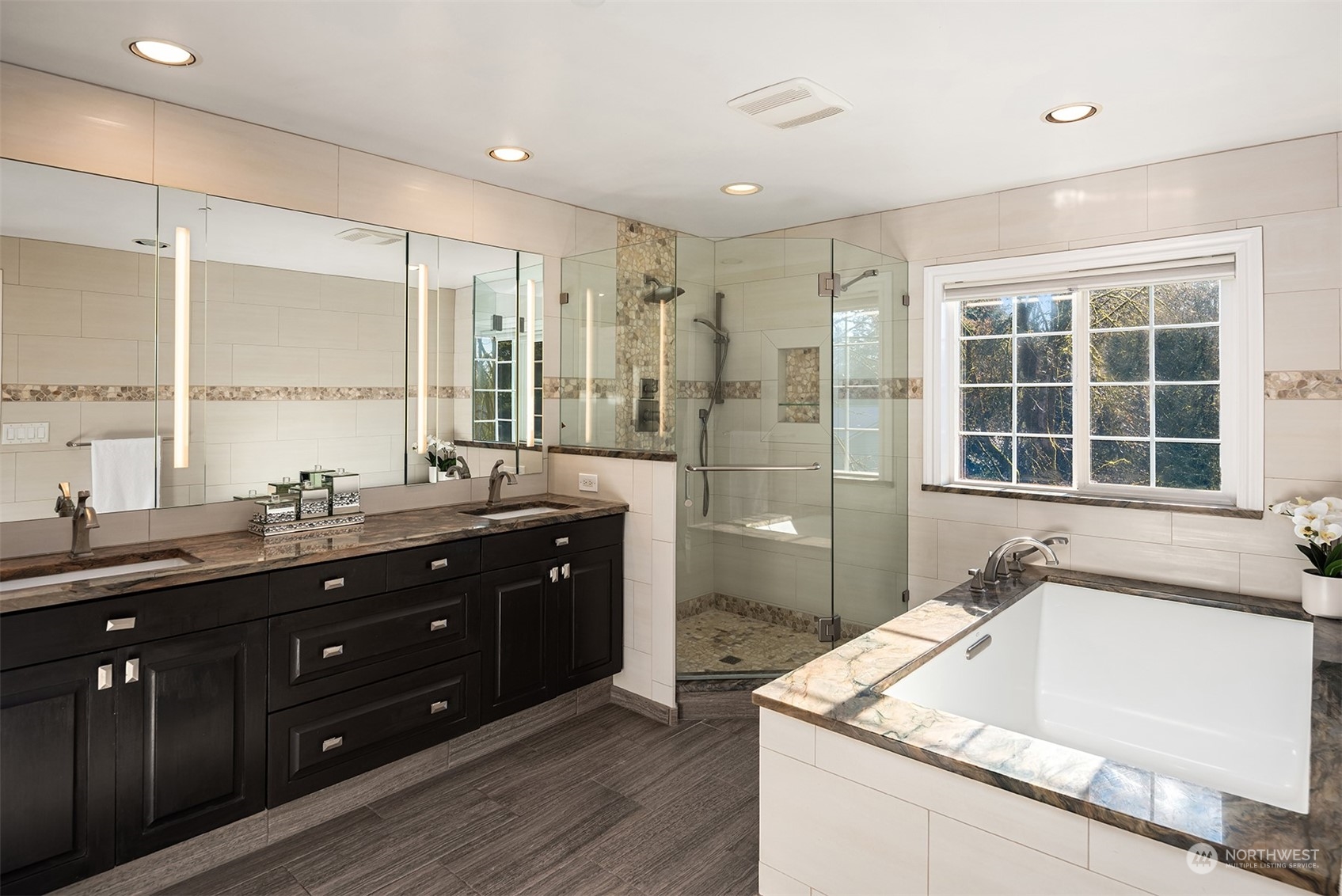 Luxurious primary bath with jetted tub and granite upgrades.