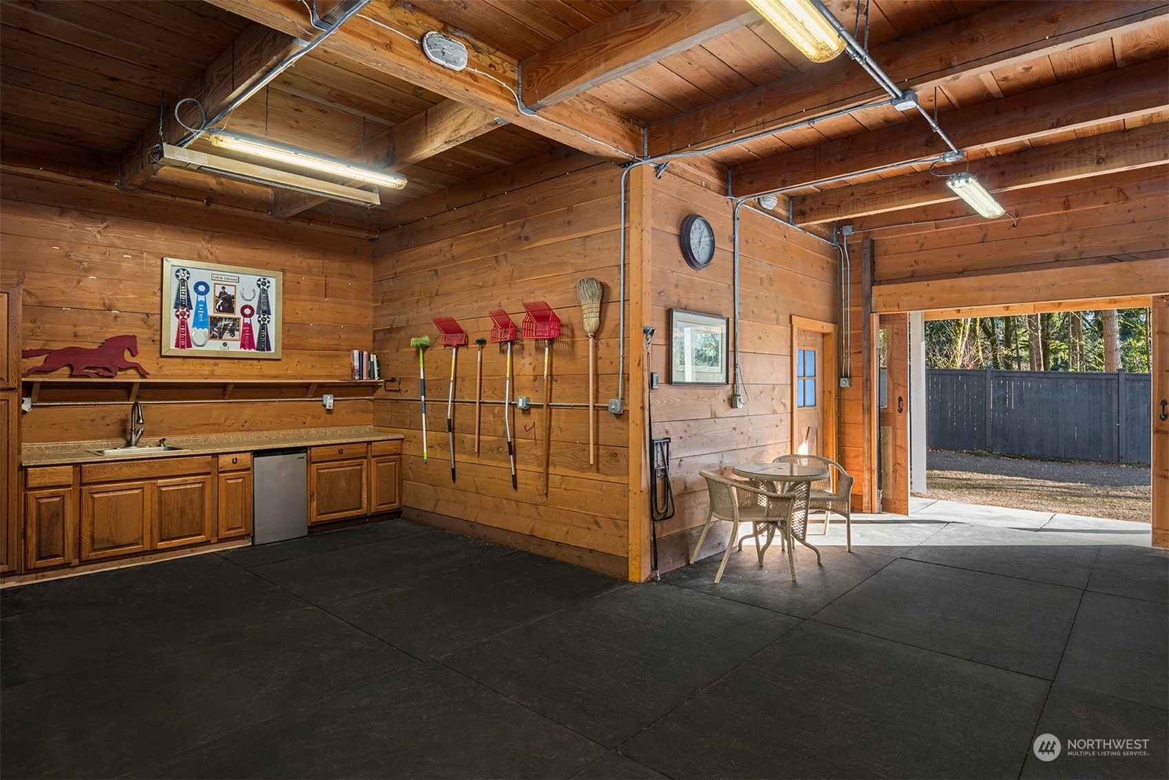 Heated grooming area, spacious tack room & kitchen, high ceilings, dutch doors, 6-ton hay storage with 500-gallon water tank.  Well water supplies barn and pastures.