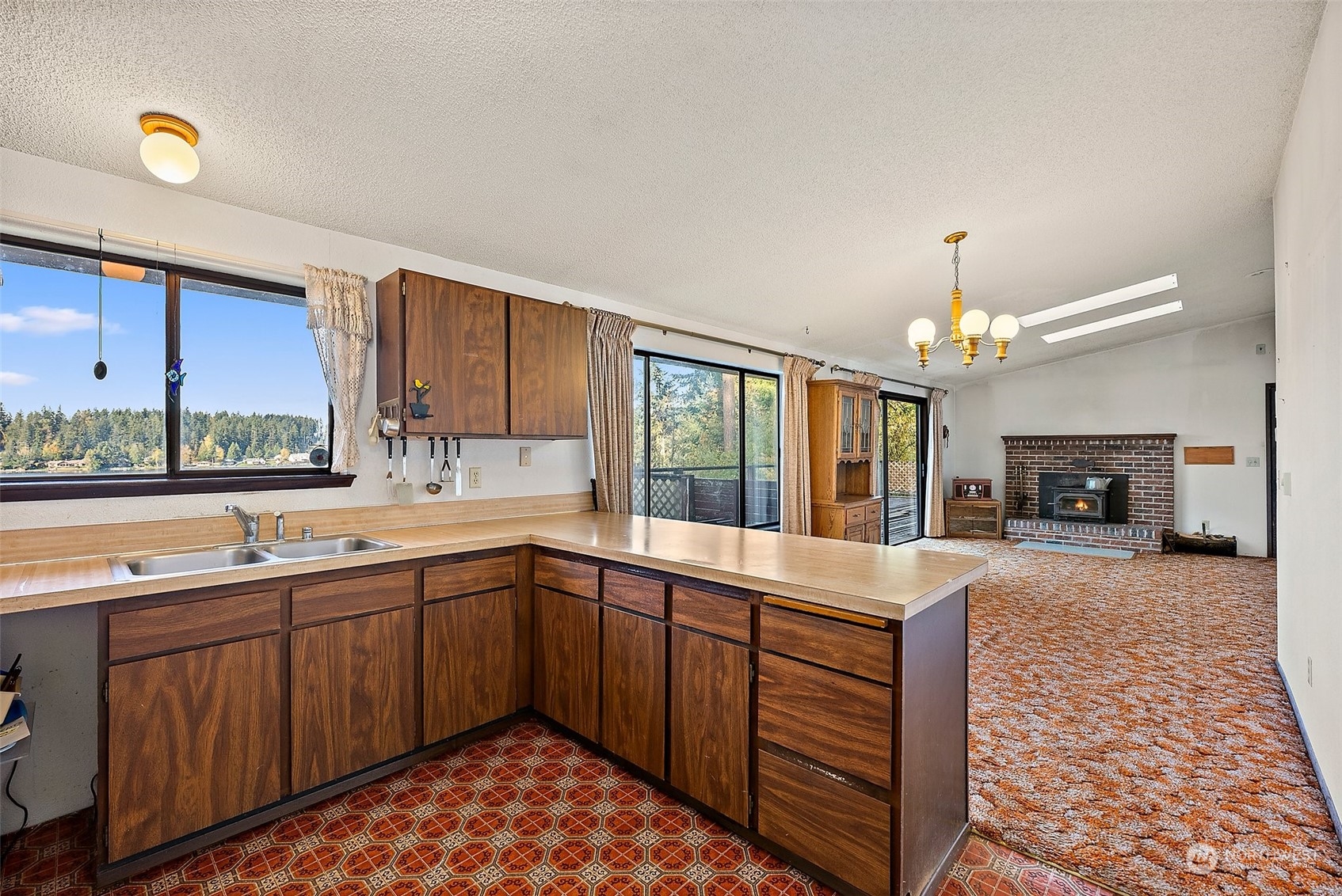 Main Floor - Living Area and Kitchen. Sliding Glass Door Open to Decking.