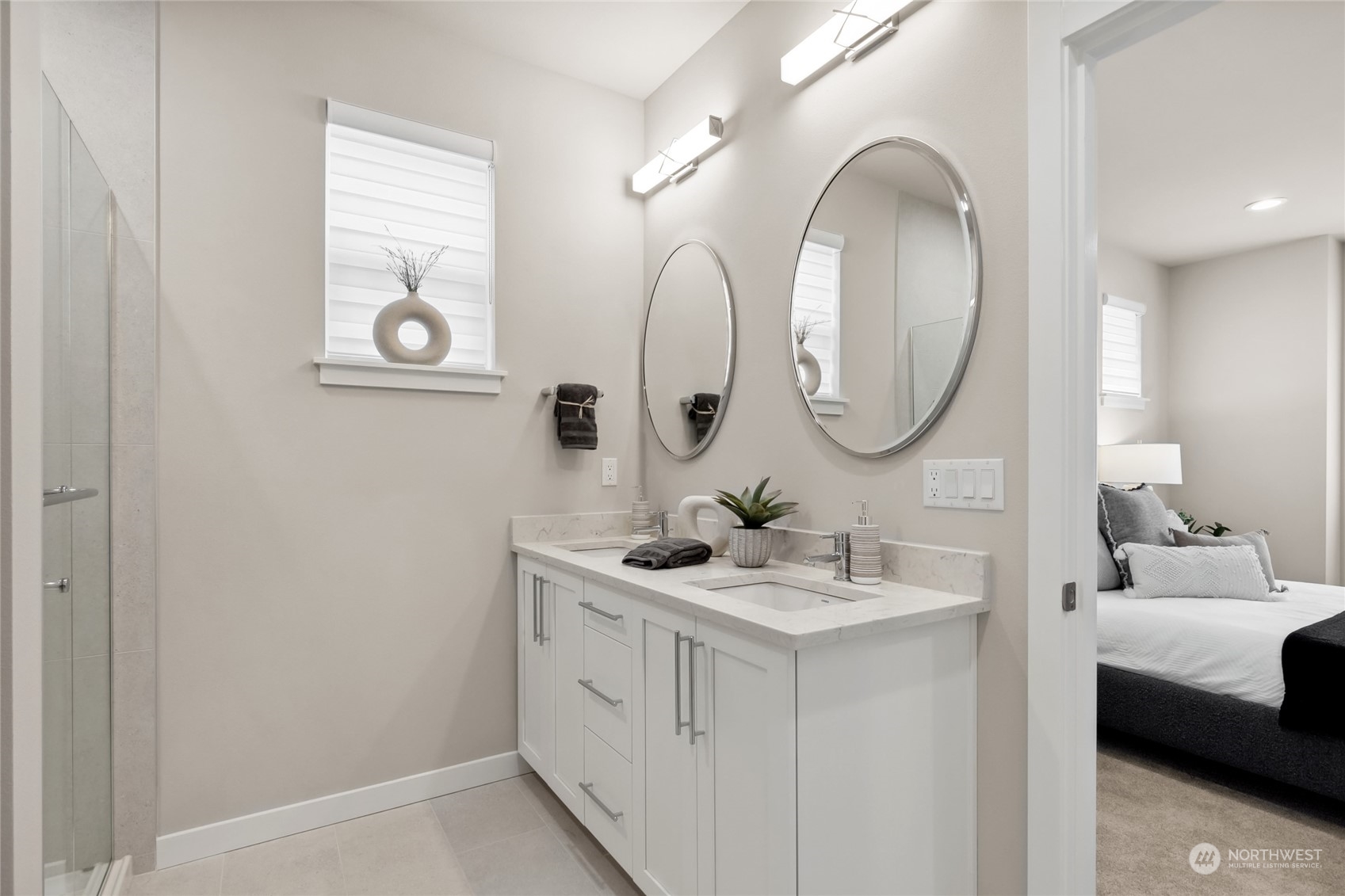 Primary bathroom with double sinks and separate mirrors.