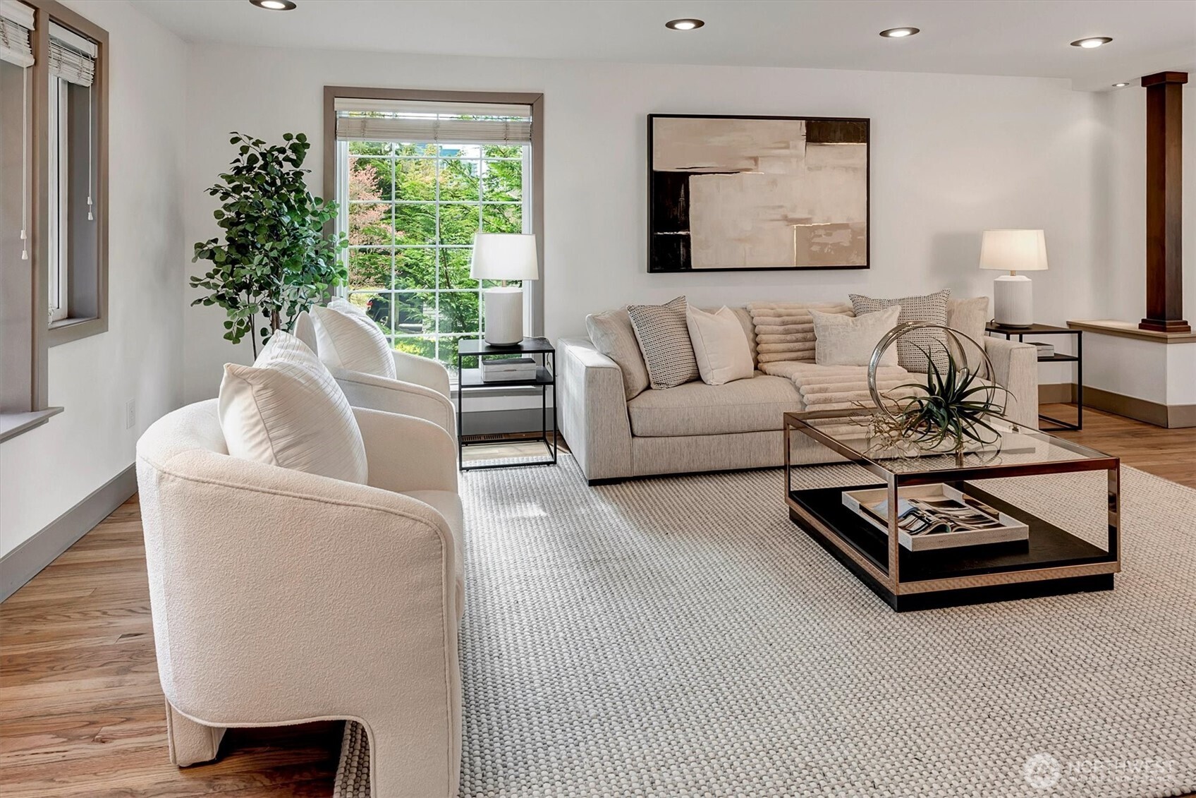 Formal living room off the foyer offering lots of natural light. Beautiful hardwood floors