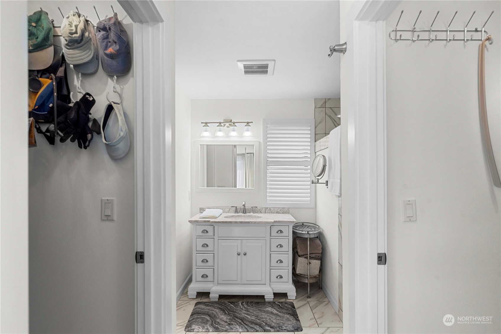 The primary ensuite includes walk in closets on each side of this hallway.