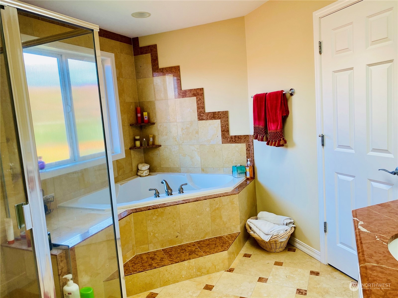 Primary bedroom showcasing balcony that overlooks the backyard.