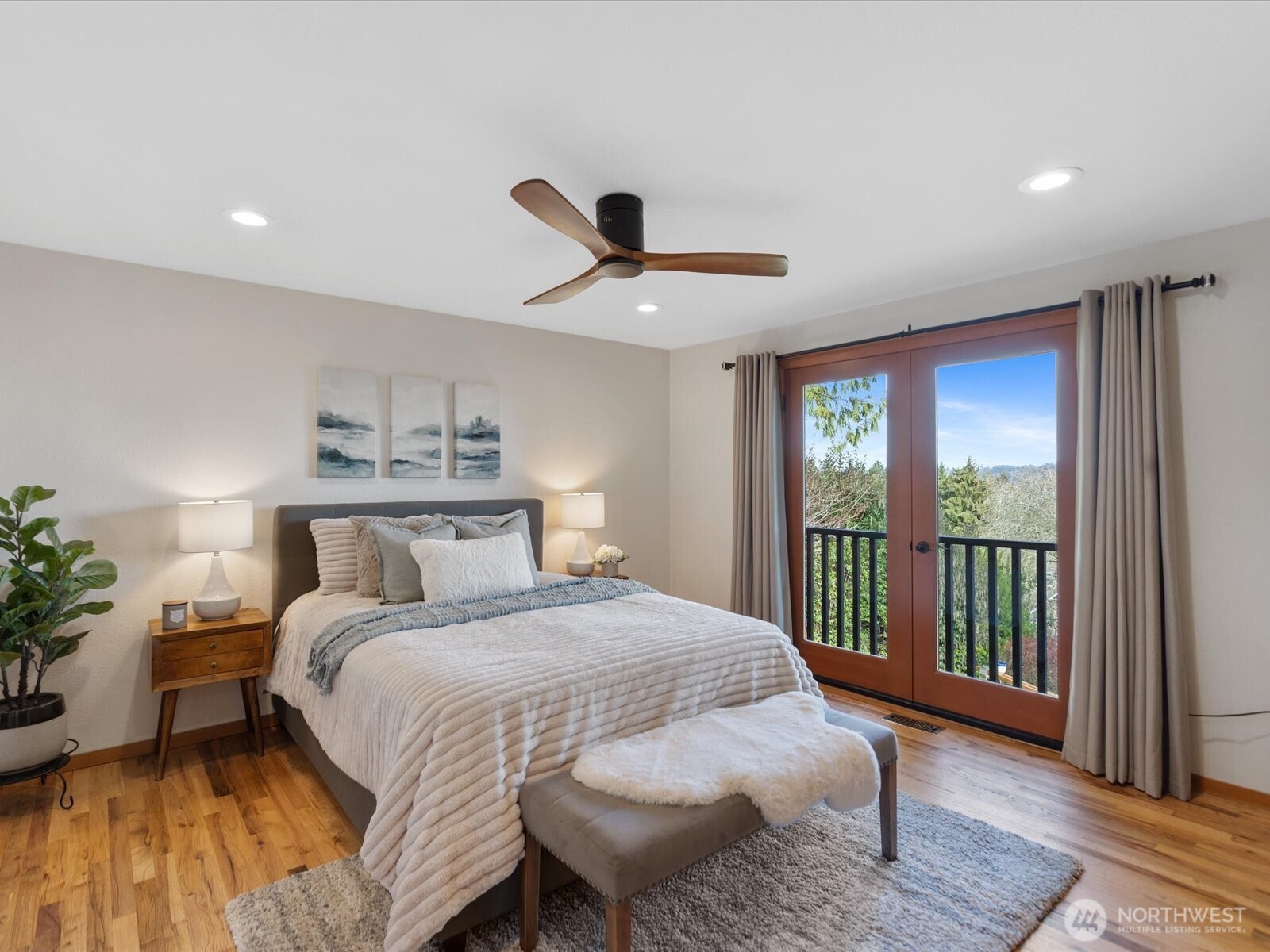 Primary bedroom features French doors to private deck.