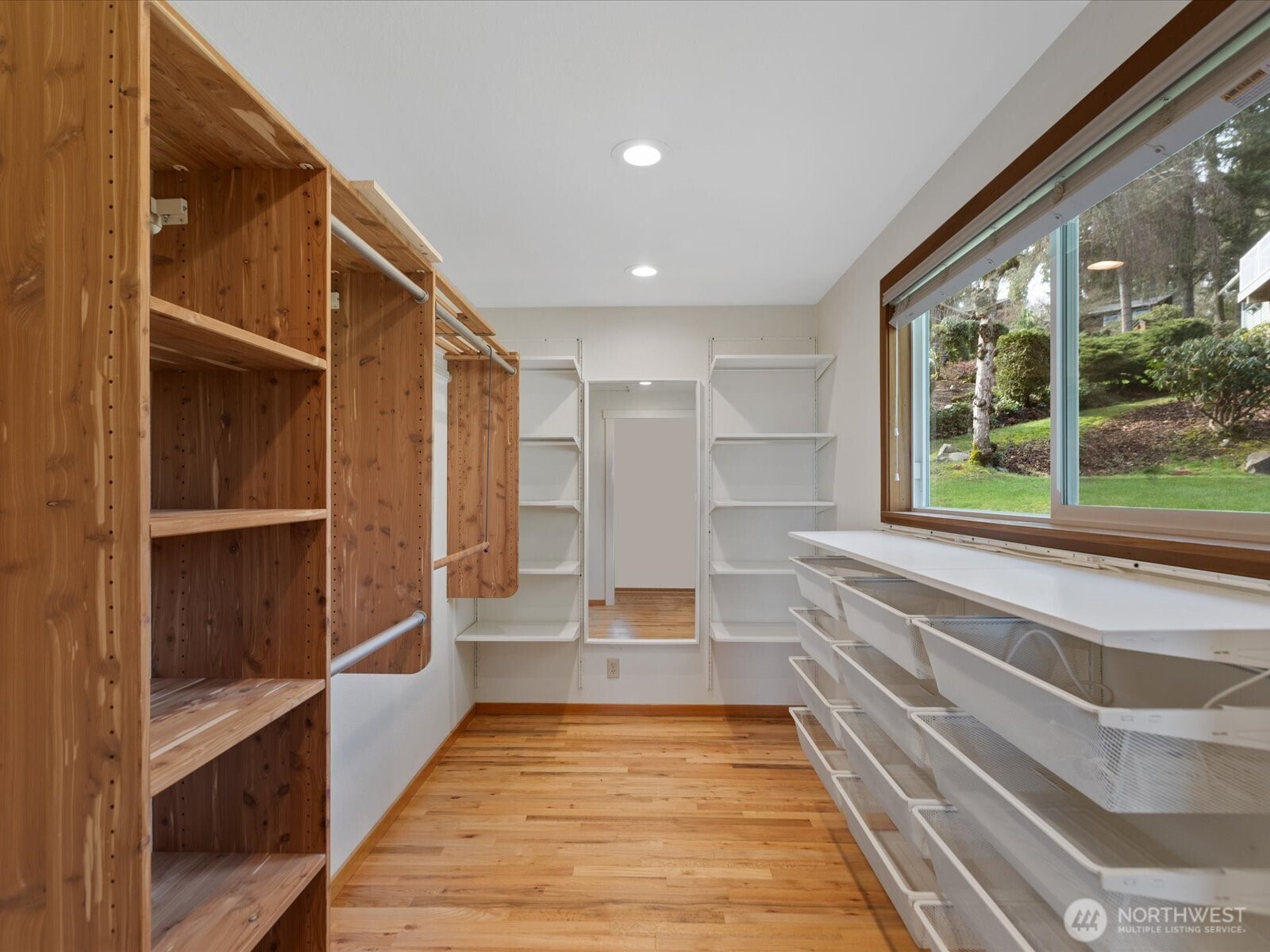 Walk-in closet with custom cabinetry.