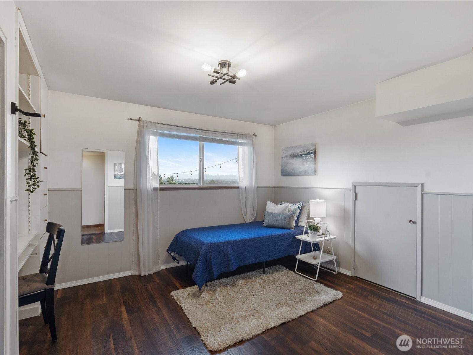 3rd bedroom with LVP flooring and built-ins.