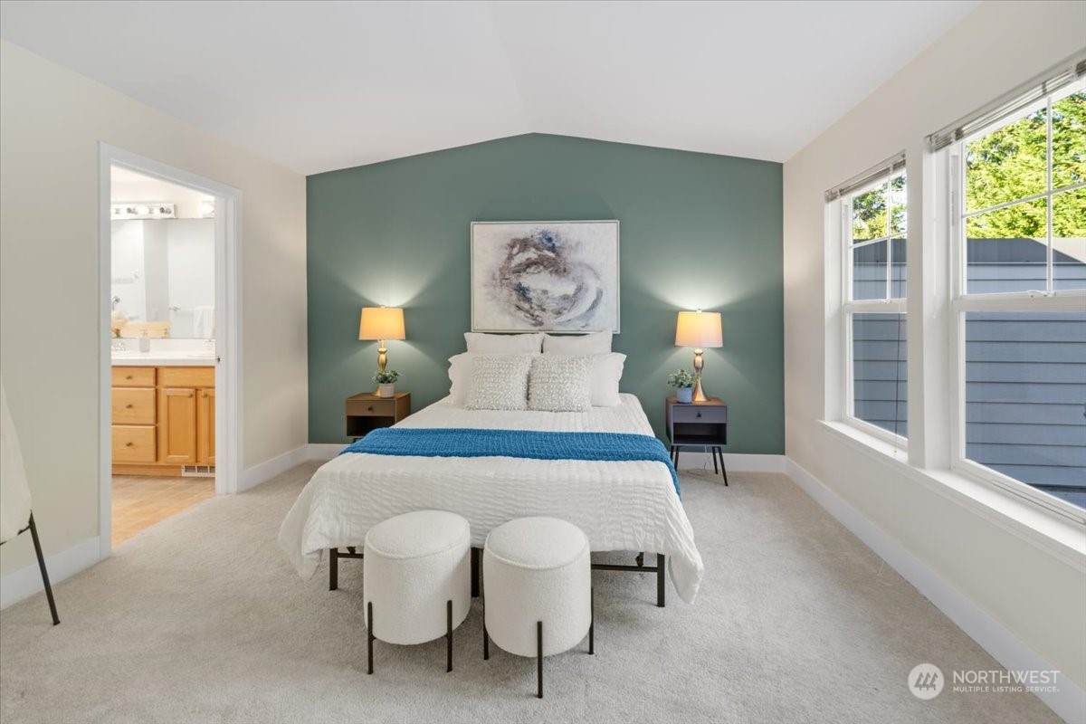 The primary bedroom can comfortably accommodate a king sized bed with furniture.  Notice the vaulted ceilings.