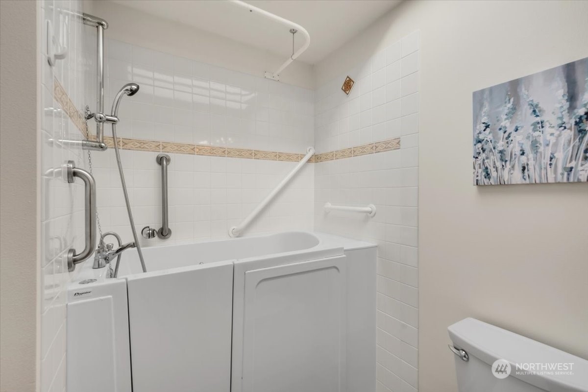 The primary bath has a conveniently accessible walk-in/sit-in tub shower.