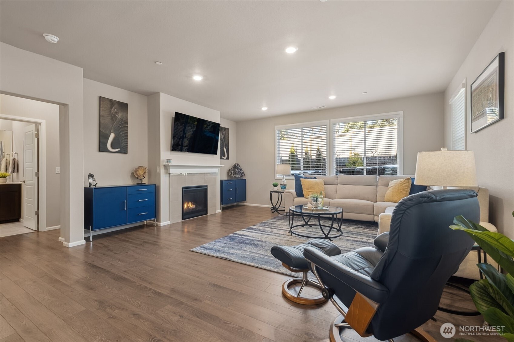 The family room is bright & cheerful ... and cozy thanks to the gas fireplace for those Pacific Northwest rainy days! -- The blue hand-built sideboards flanking the fireplace STAY!