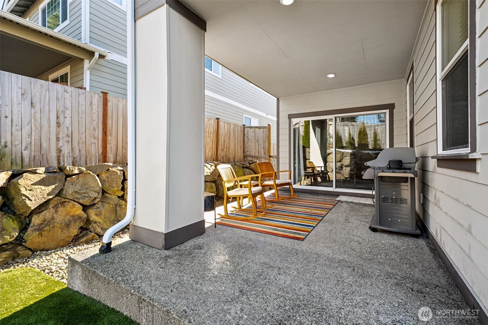 Covered patio with plenty of space for your grilling and entertaining needs!