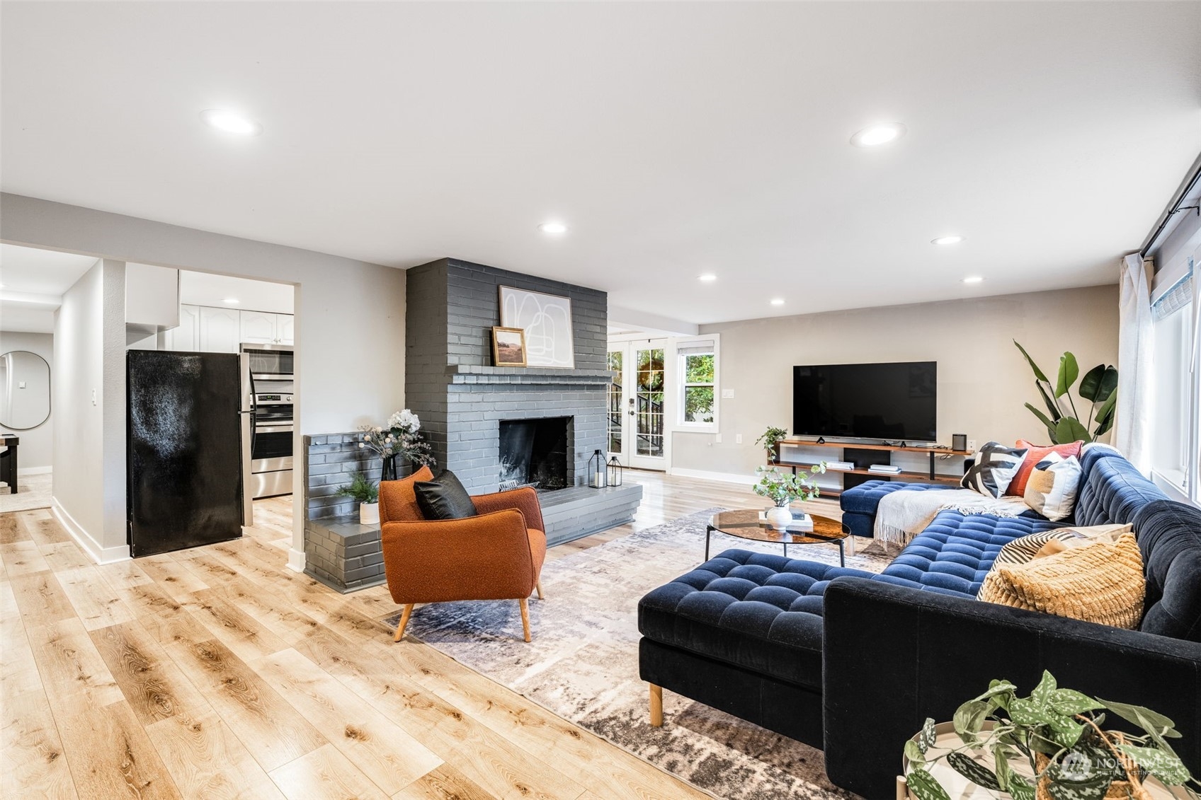 Unit C Living Area, partial view of kitchen and entrance