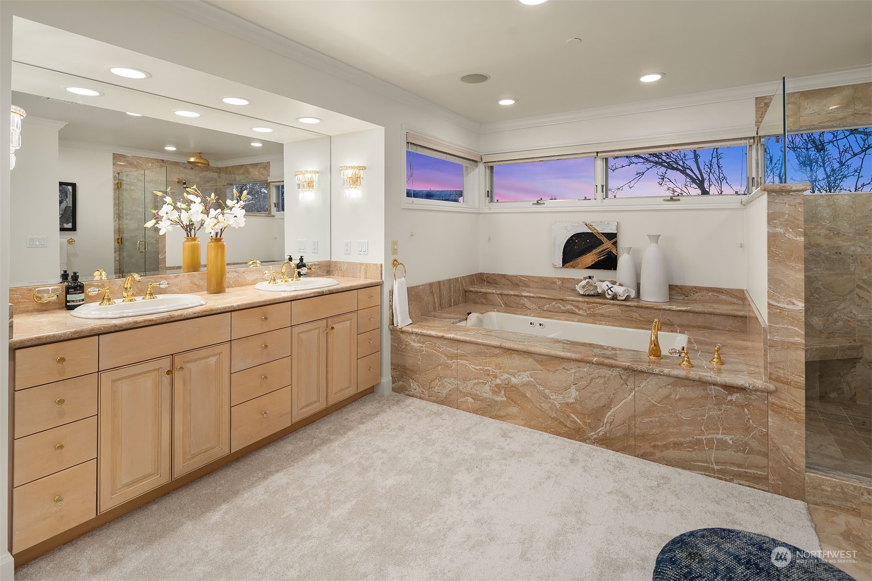 Marble surround soaking tub and shower offer the ultimate spa experience.