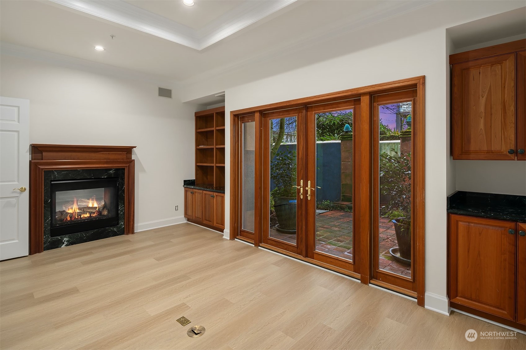 This is the 'Board' room with two-sided fireplace and french doors to the brick patio.