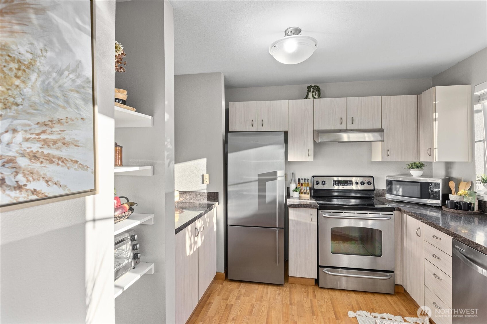 Kitchen has quartz counters and SS appliances.