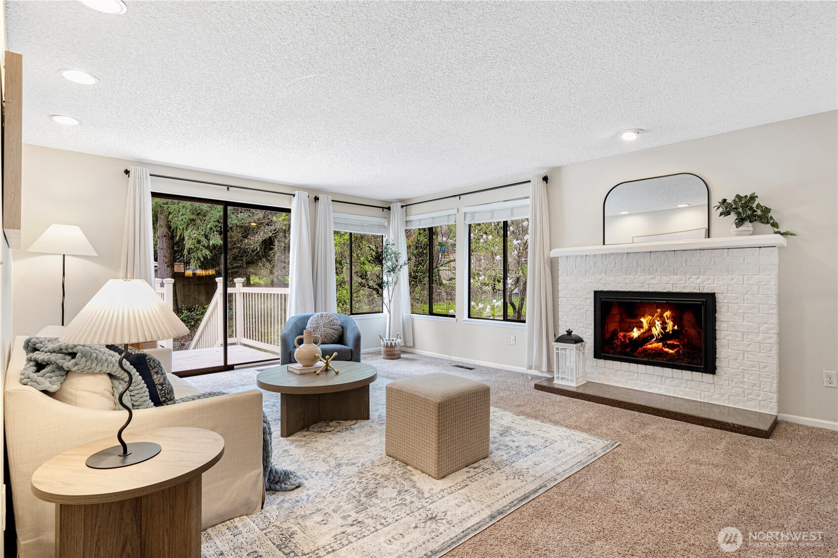 Living room with fireplace and access to deck.