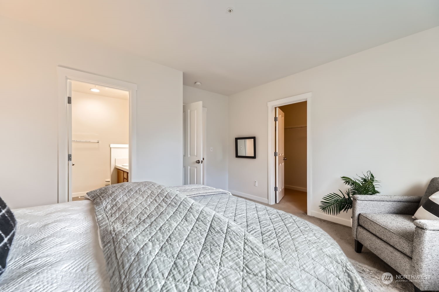 The primary bathroom features a double vanity and large linen closet next to the standing shower.