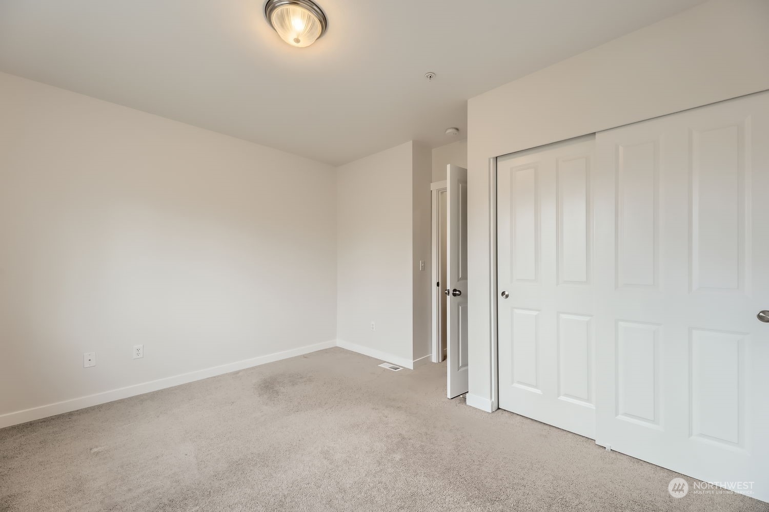 Spacious third bedroom faces east toward the private driveway