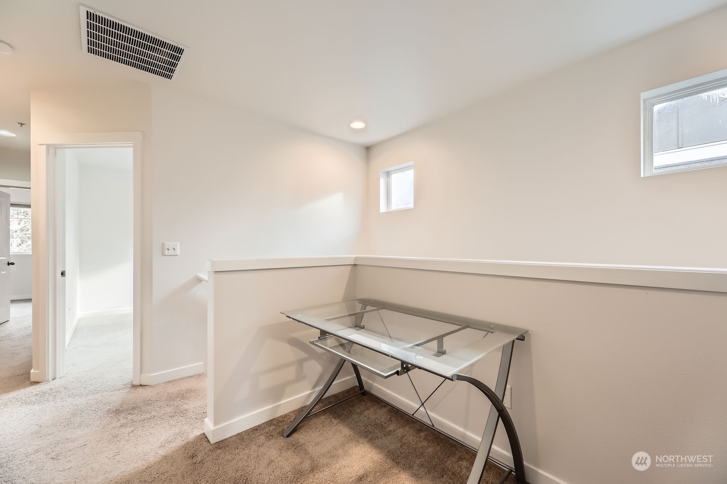 The upstairs desk nook feels airy and bright with south-facing light streaming in