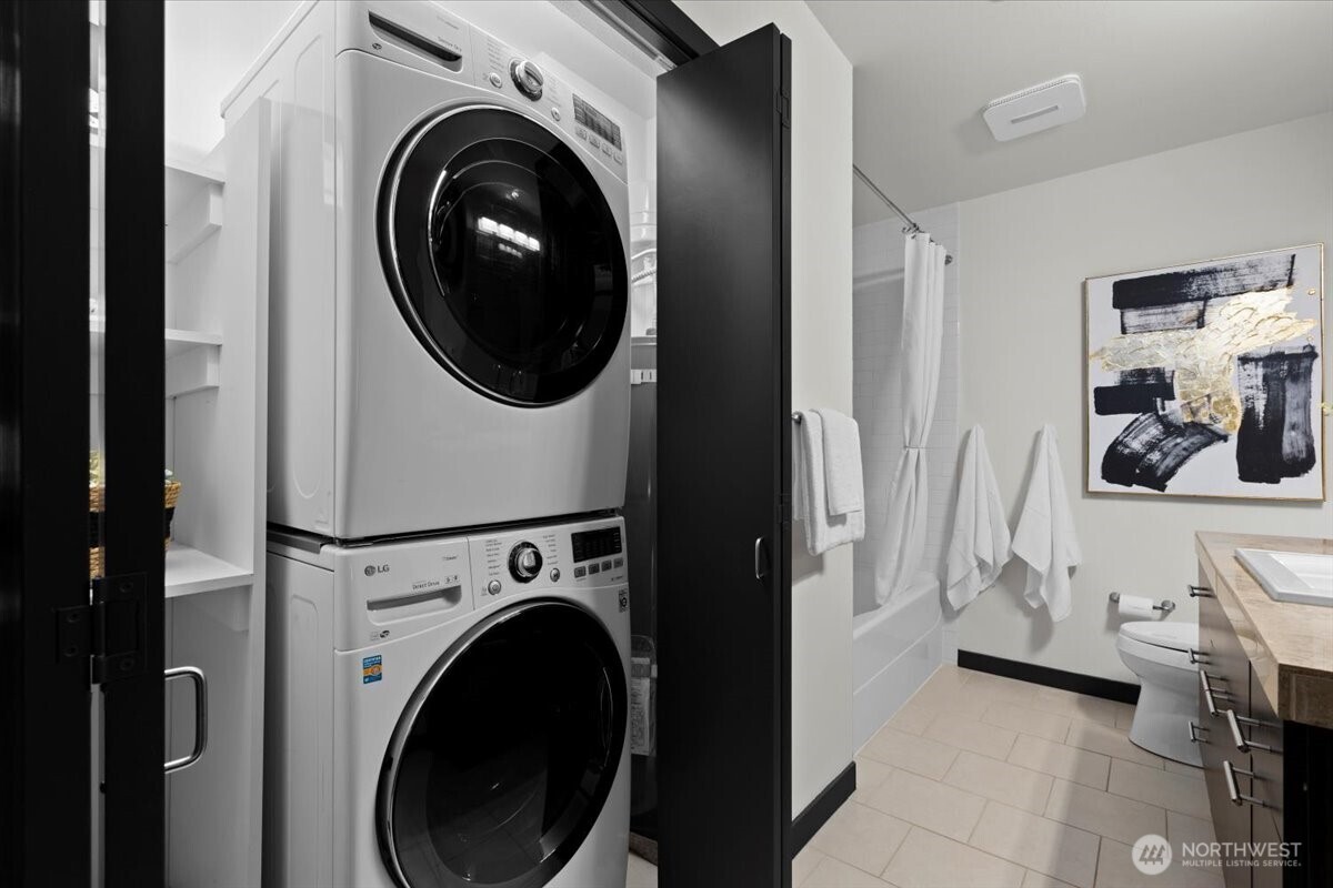 Full second bathroom w/ LG stacked washer and dryer