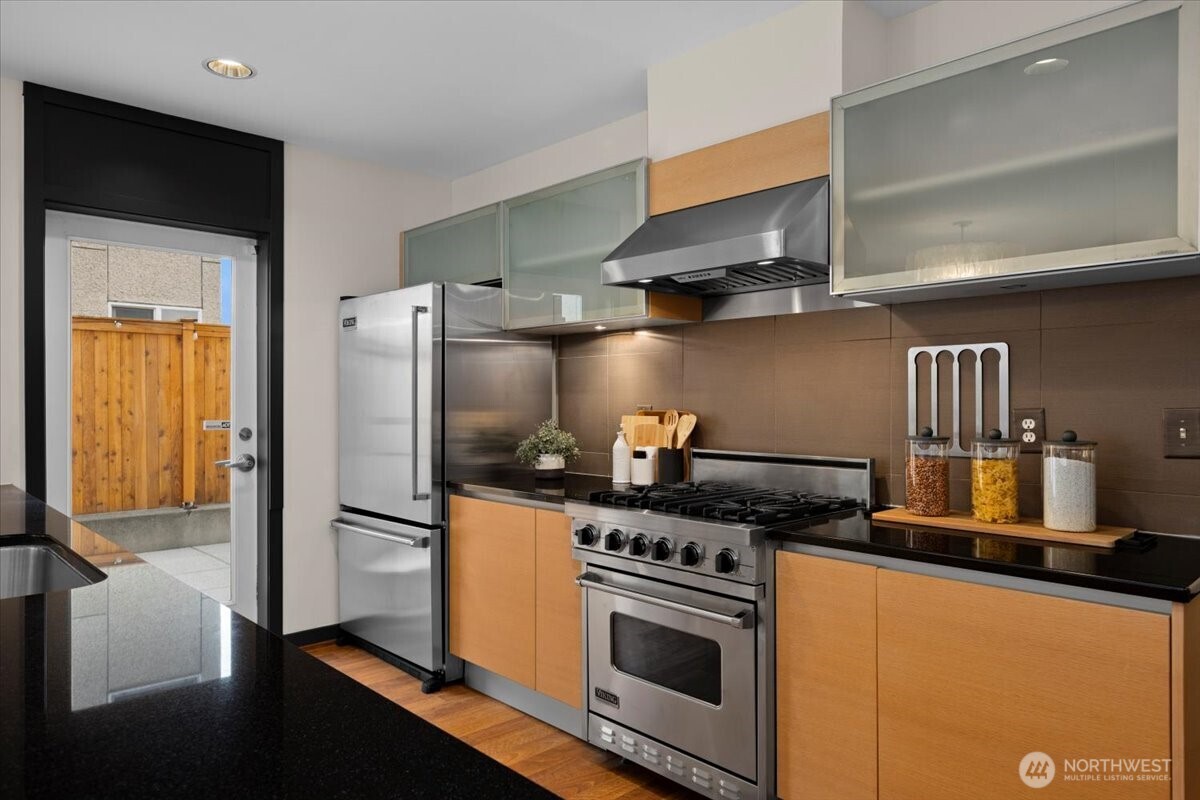 Chef’s kitchen with Viking stainless steel appliances and easy access to side/back patios