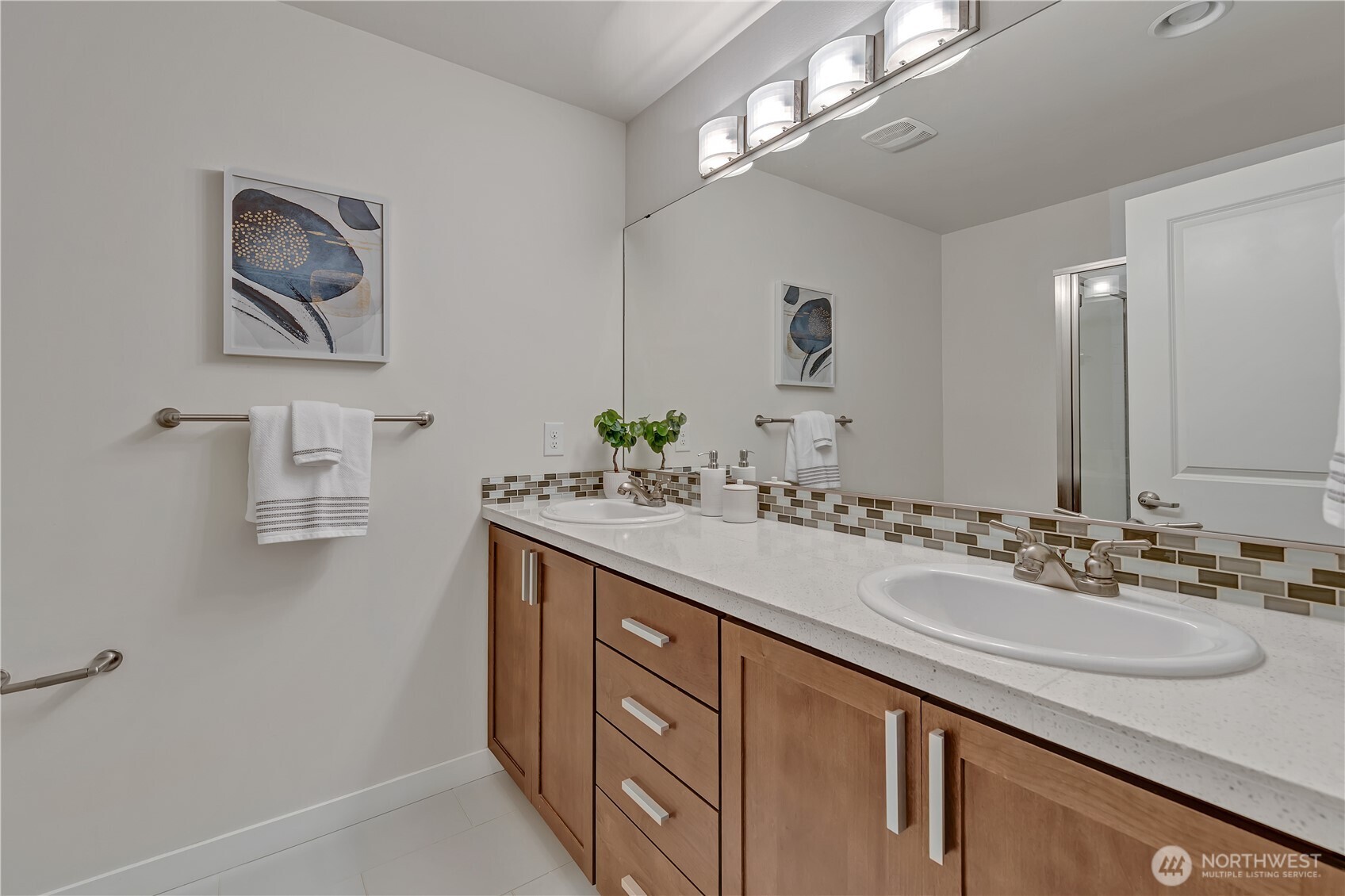 Primary bath with a dual sink vanity and shower.