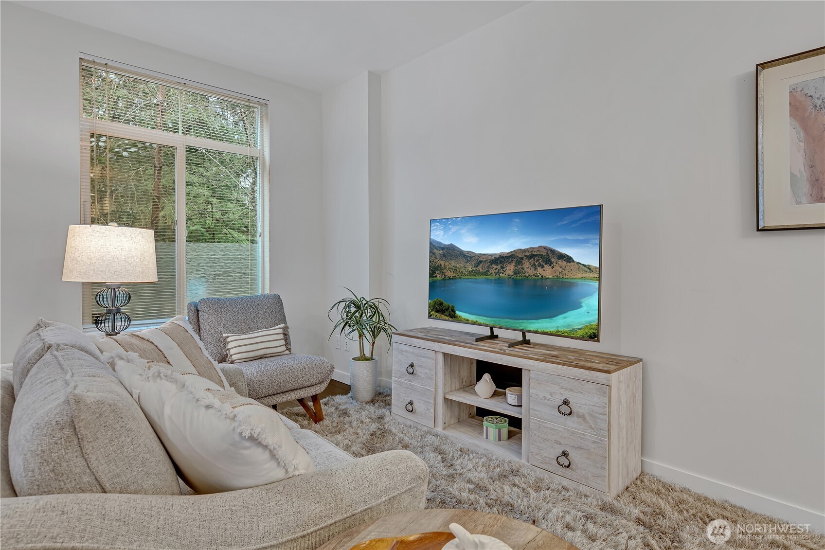 A large window in the living room lets in the natural light.