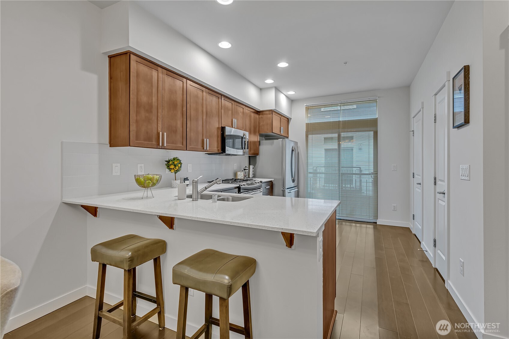 The well-appointed kitchen features stainless appliances and an eating bar for quick grab and go meals.