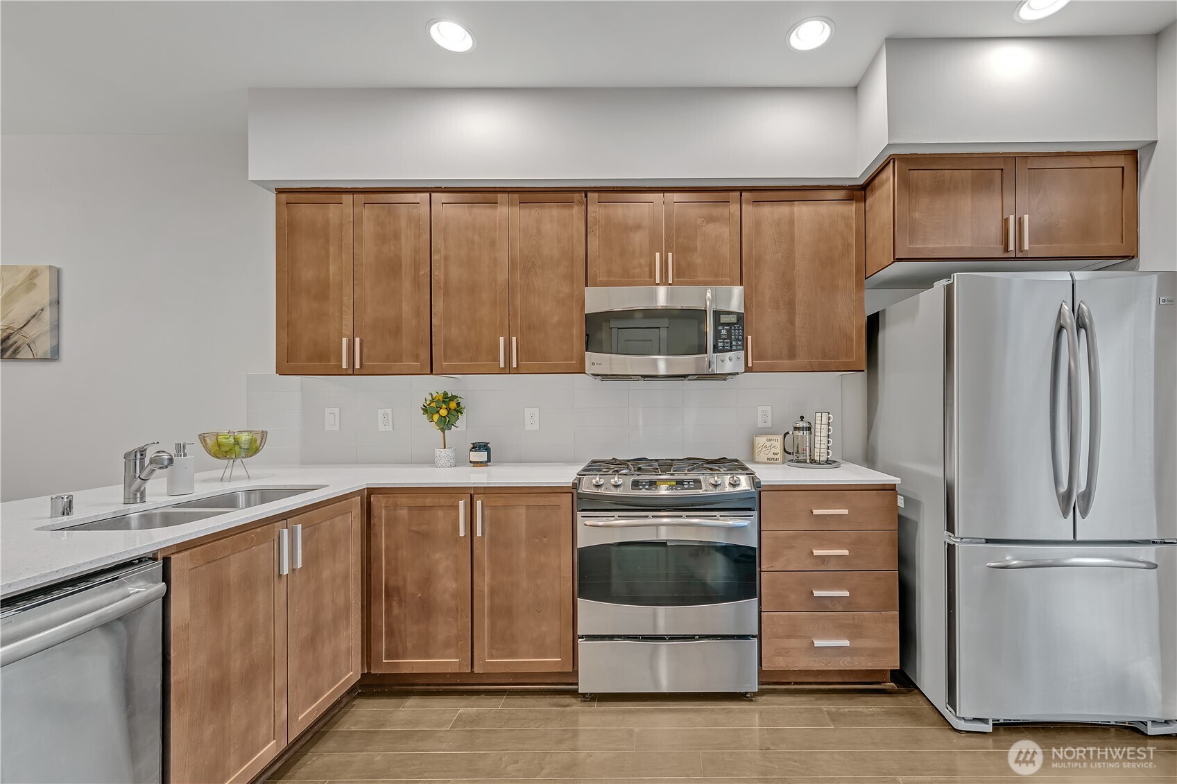 Sparkling countertops and a full height backsplash add to the appeal of this kitchen.