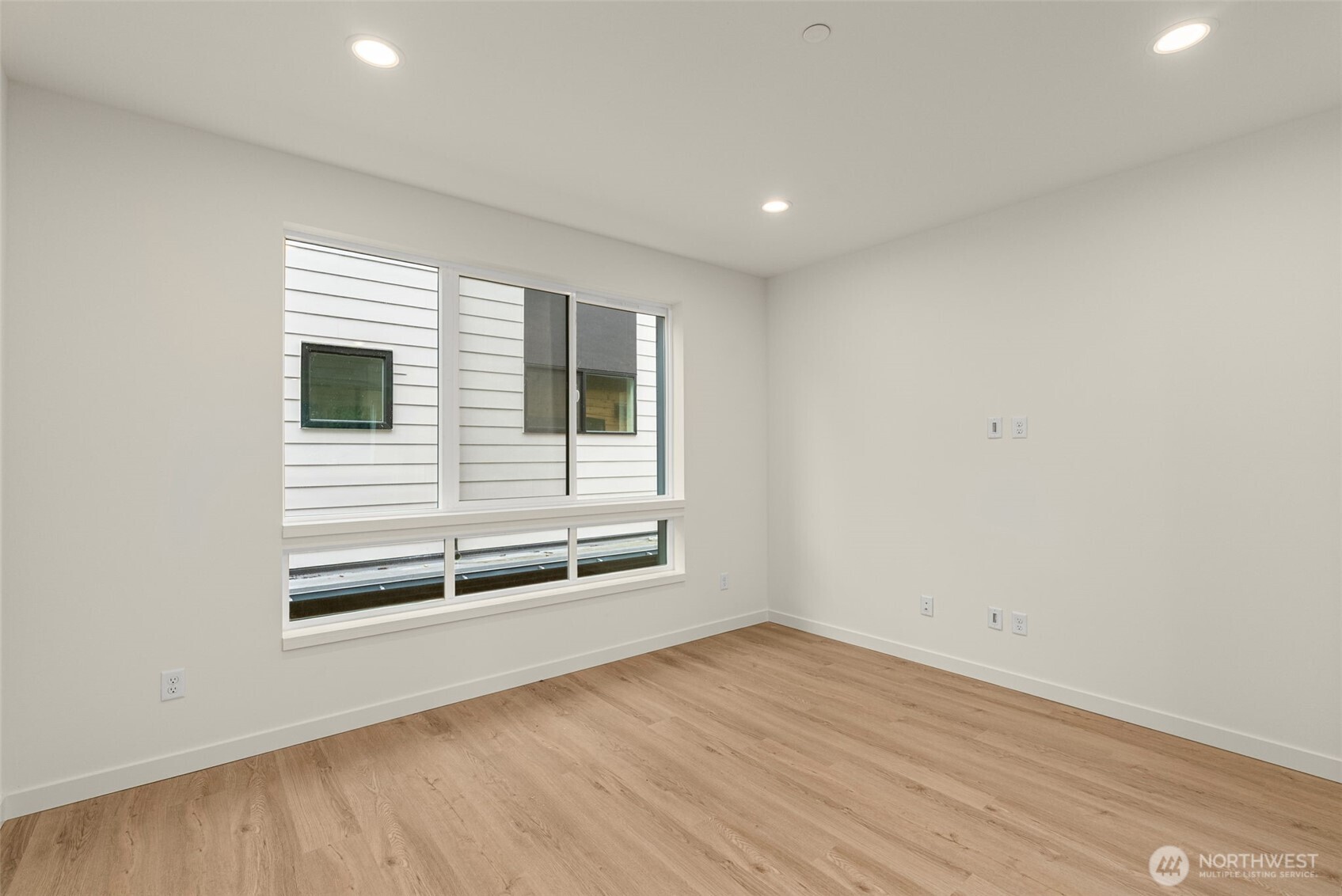 One of three spacious bedrooms with oversized windows to keep things airy and bright.