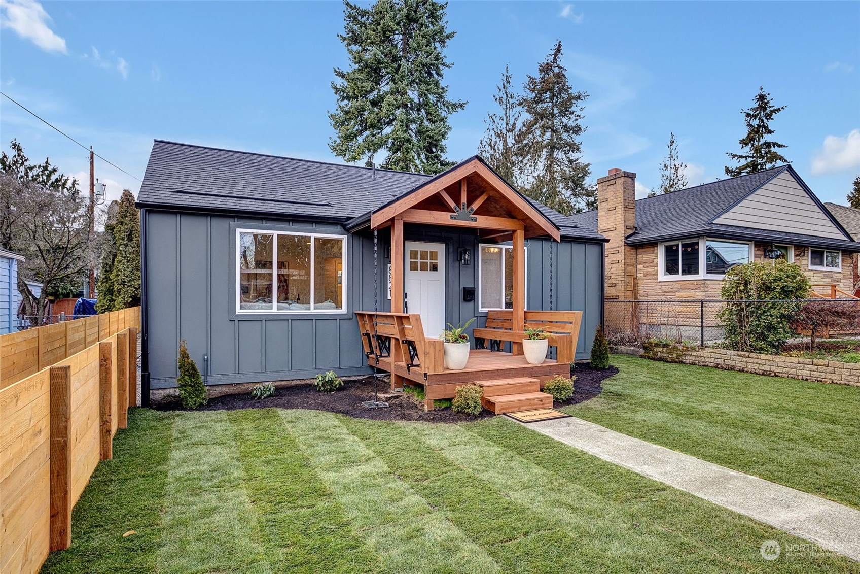 Custom front porch reimagined and superbly built with seating for 6, new roof, new paint, new grass and fences!