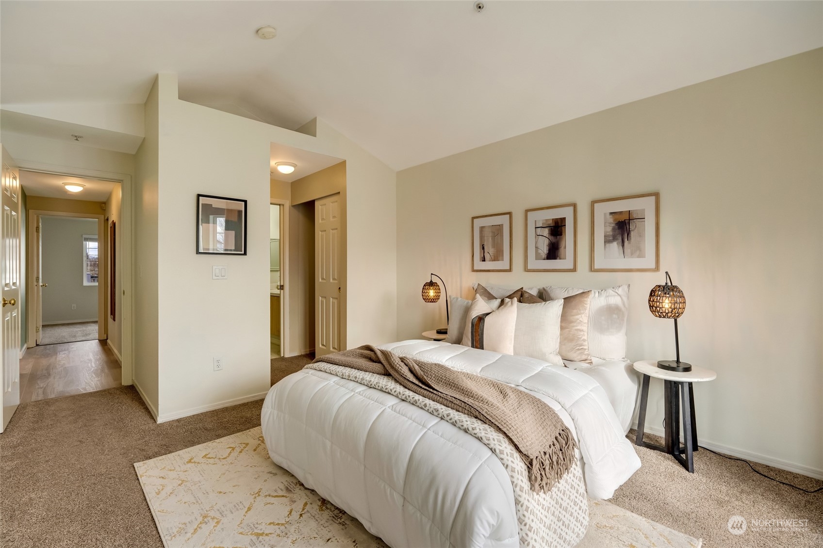 Primary bedroom leading into continental full bathroom