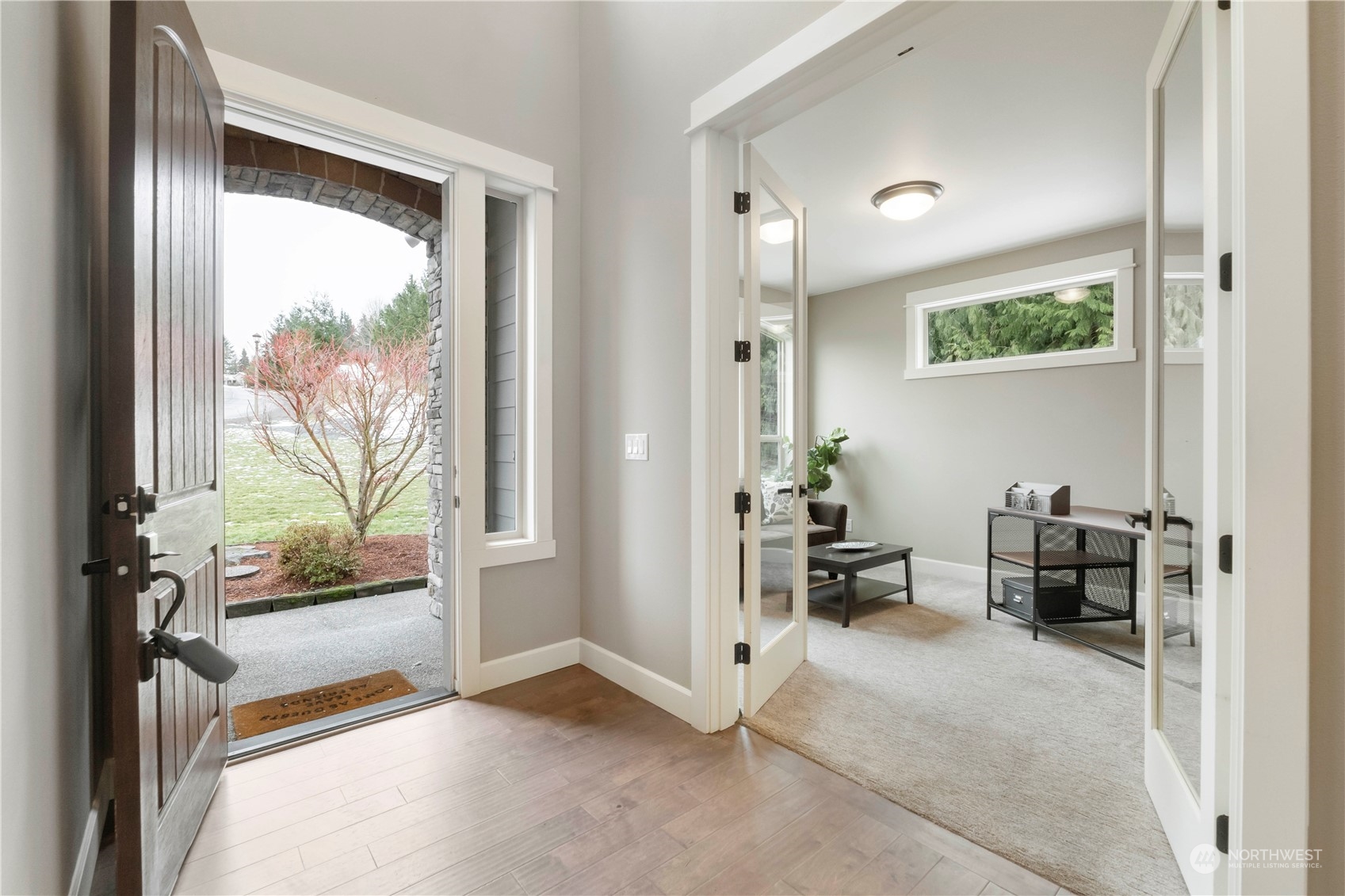 Light and bright entry leads into private office with glass French doors