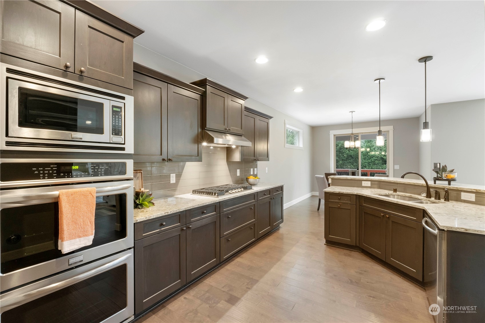 Spacious gourmet kitchen featuring island, double ovens, new gas cooktop and walk in pantry