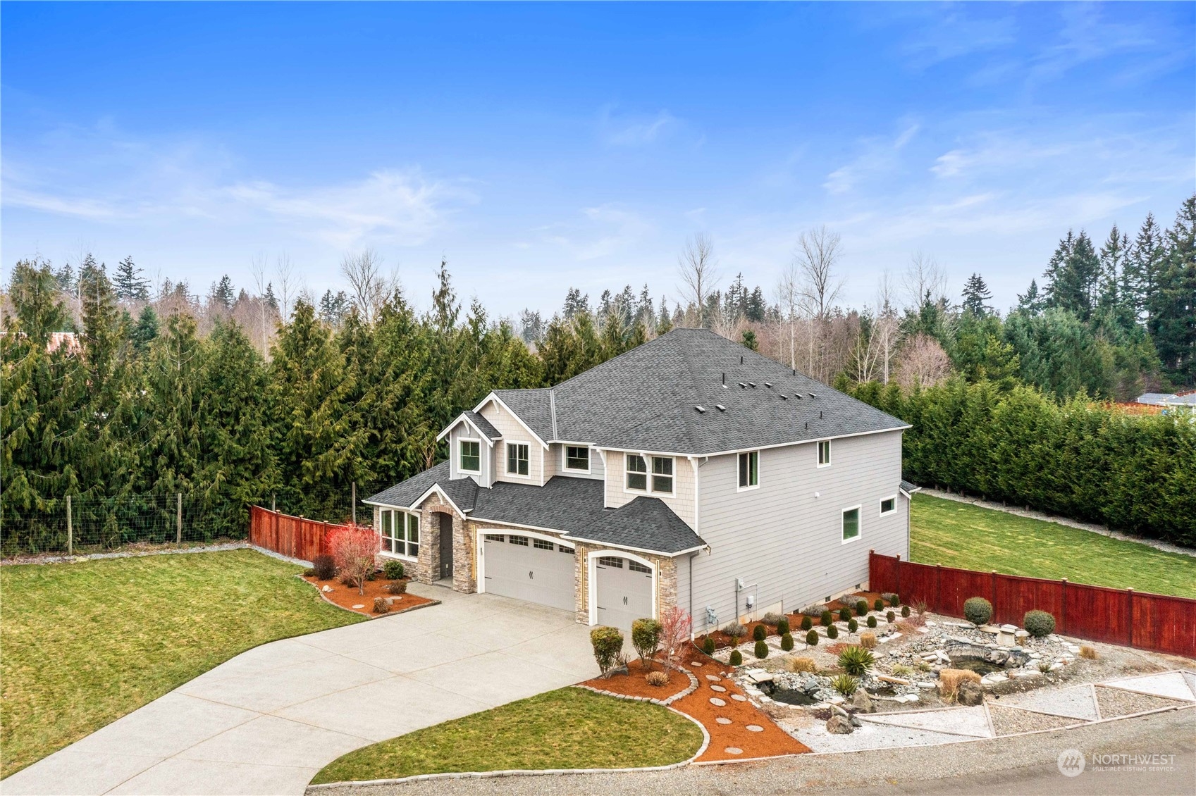 Privacy abounds in this fully fenced 1.7 acre home surrounded by tress in the backyard