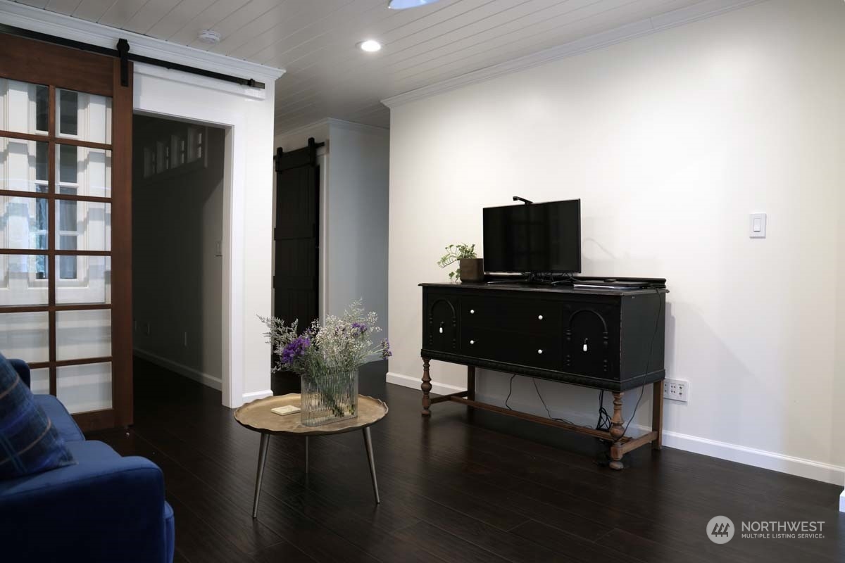 Living area with entrances to the secondary bedroom, and kitchen. The Primary bedroom and bath are down the hall.