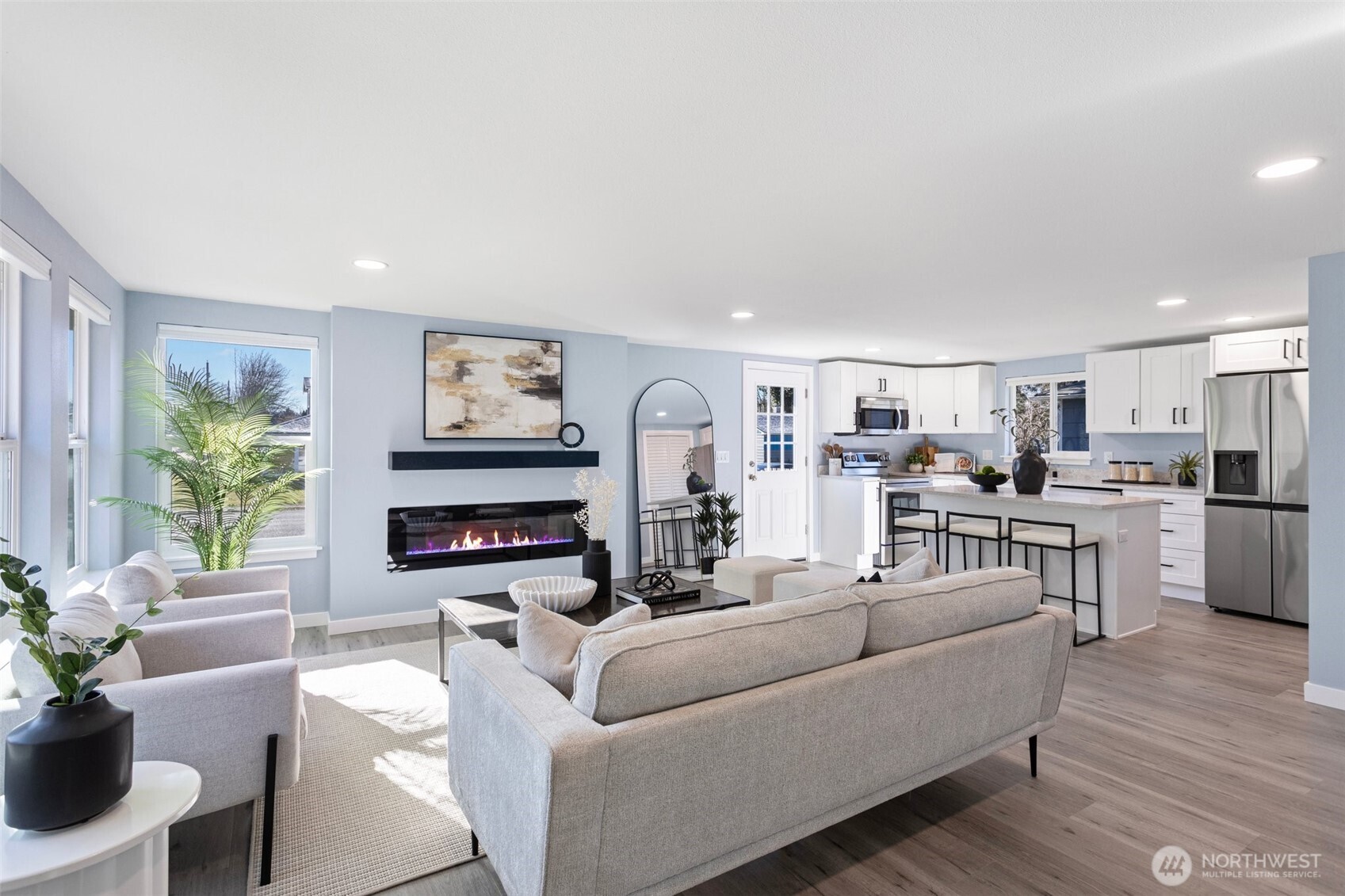 The open living space is perfect for entertaining and feels extra cozy with the added electric fireplace that emits heat and offers a little ambiance.