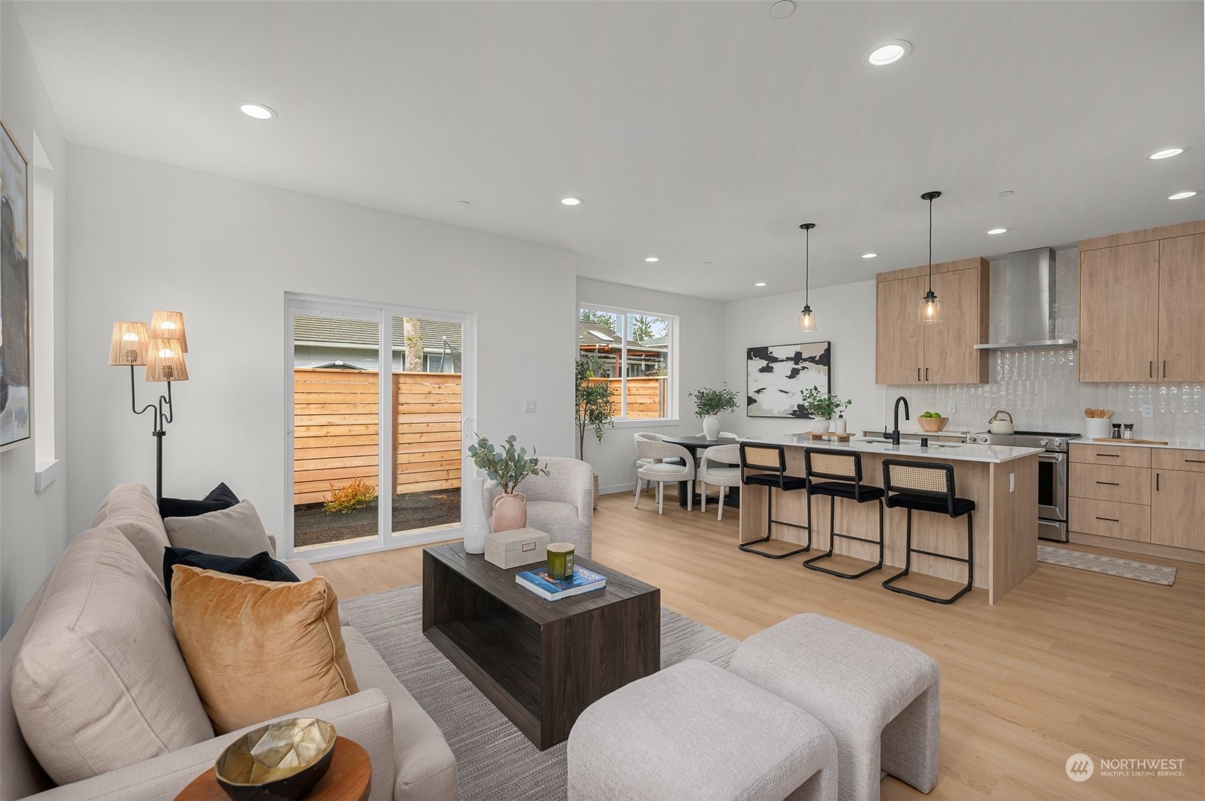 This model kitchen is an entertainer’s dream! The floating island with bar seating, pendant lighting, and natural wood cabinetry creates a functional and stylish space. Perfect for hosting or everyday moments.