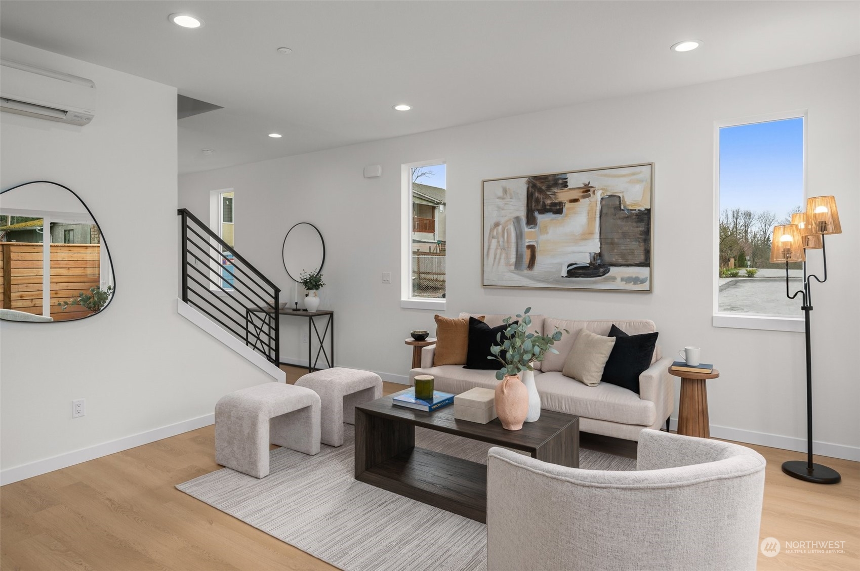 This model home features an open staircase that enhances the airy feel of the space, while soft, natural hues bring an understated elegance to the main living area.