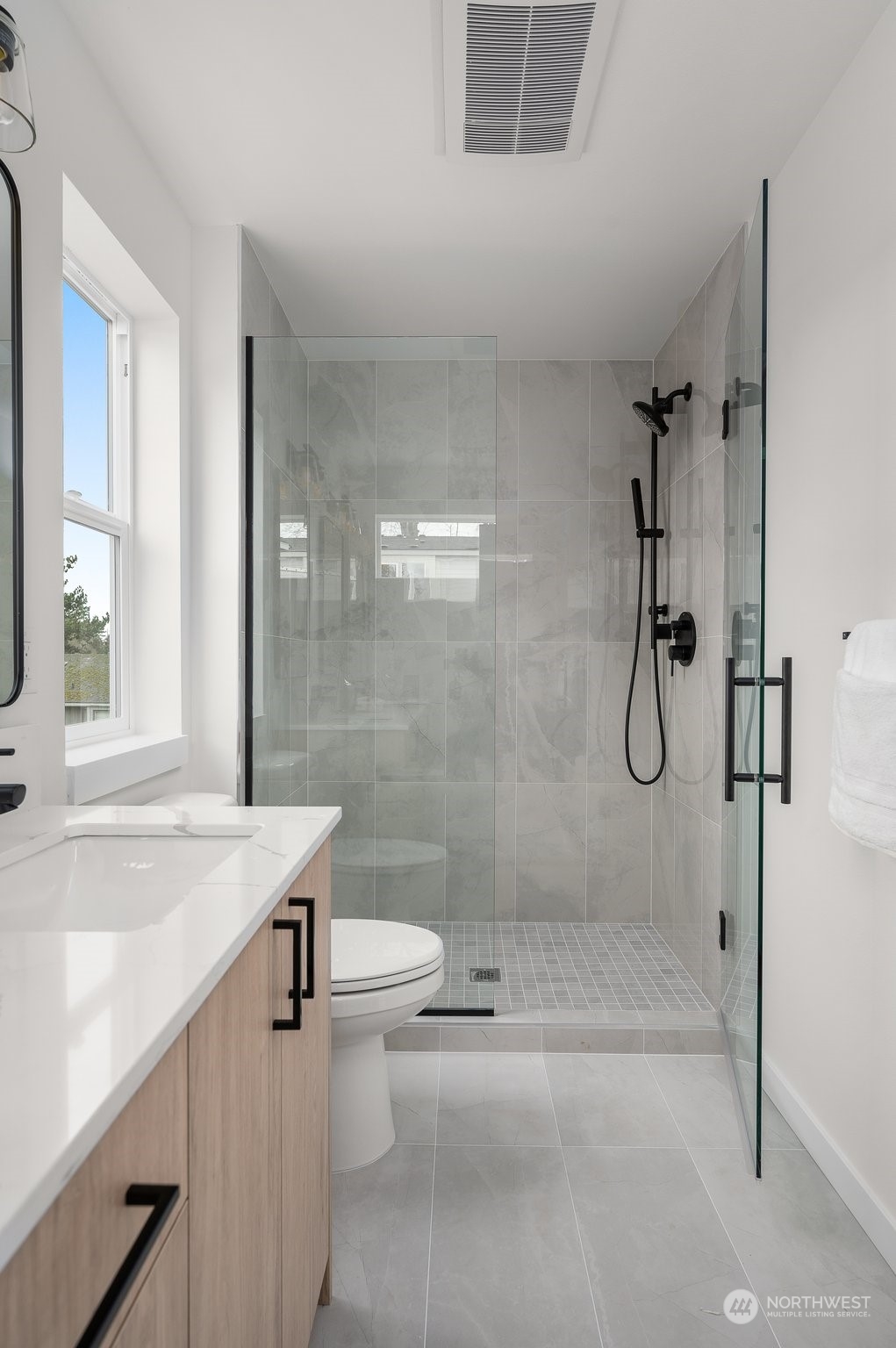 Step into a spa-like retreat with this luxurious primary bathroom. Dual vanities, sleek mirrors, and ambient lighting combine for an elegant, functional space to elevate your daily routine.