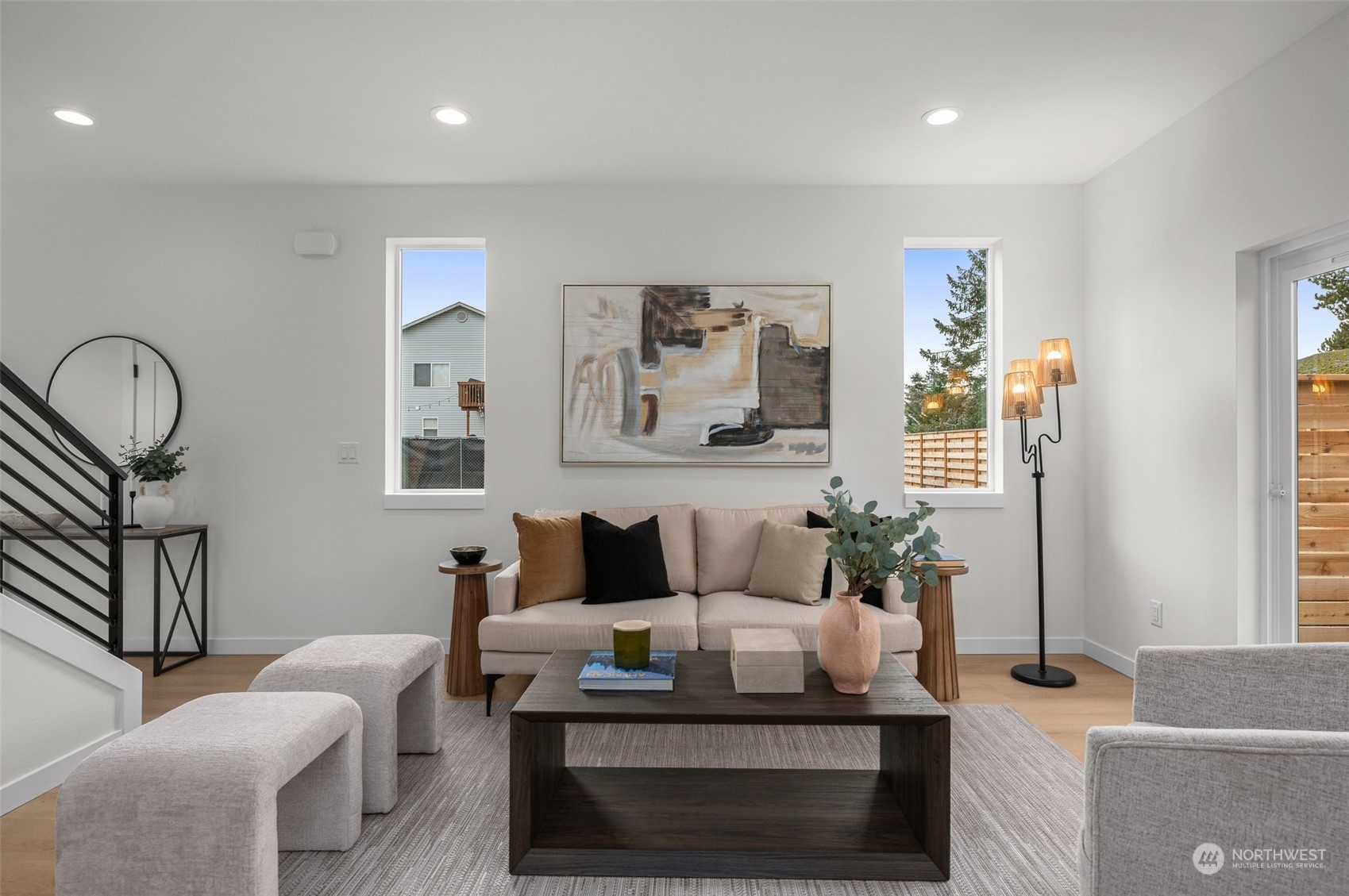 Step into a living room with natural light, where elegance meets comfort. The open floor plan and serene palette create the perfect canvas for your style.