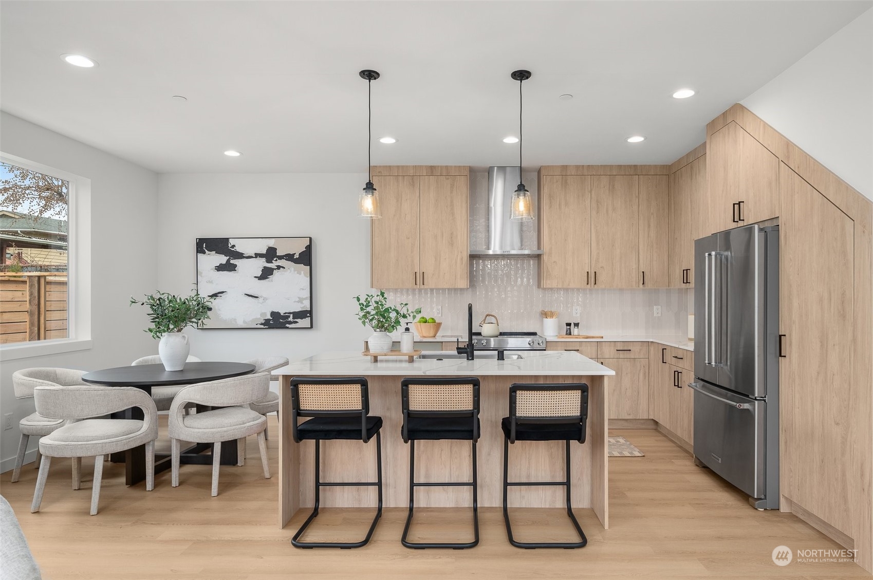 Create culinary masterpieces in this bright and inviting kitchen! With an oversized quartz-topped island and bar seating for casual mornings or lively cooking conversations.