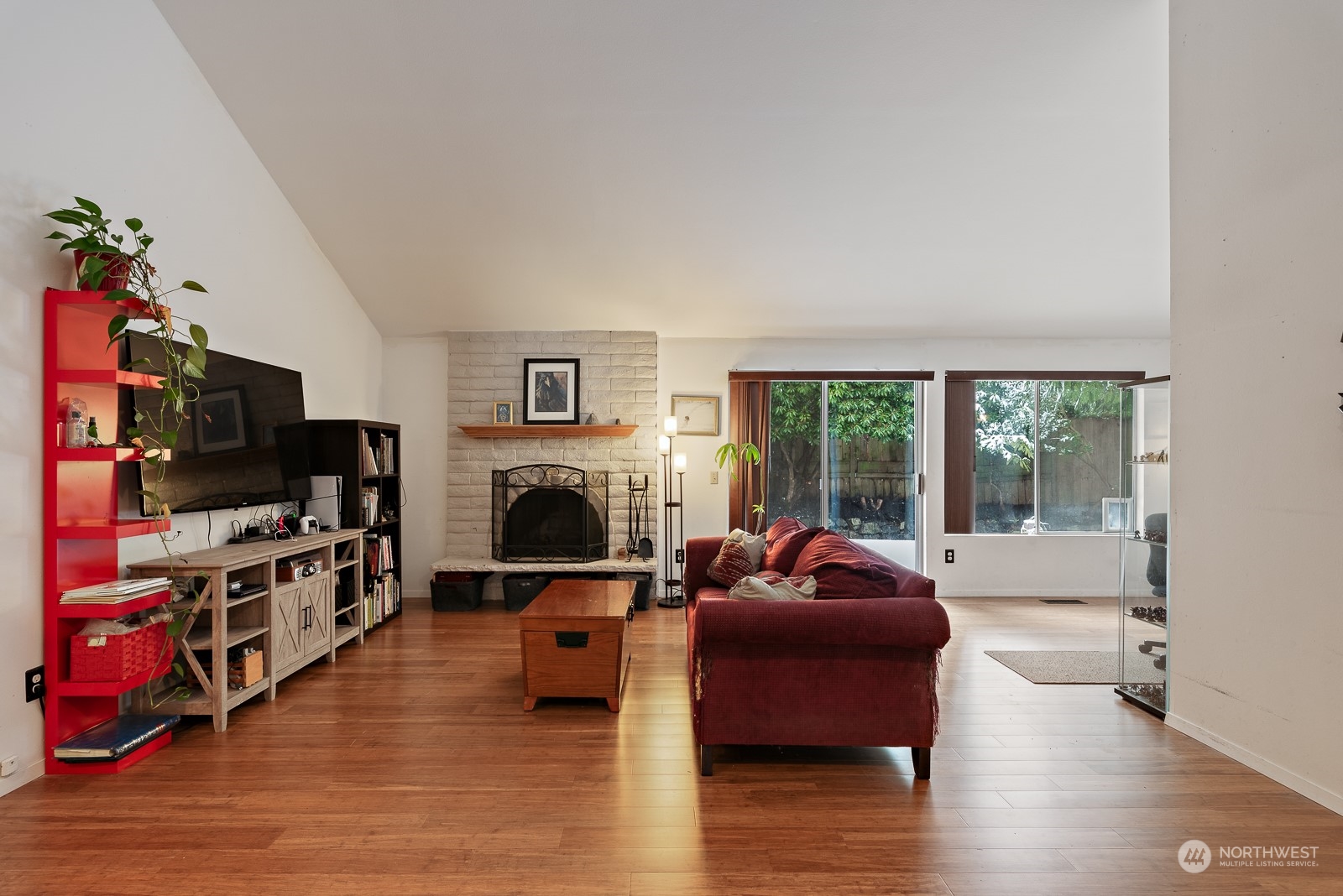 Spacious living room with vaulted ceilings and wood fireplace