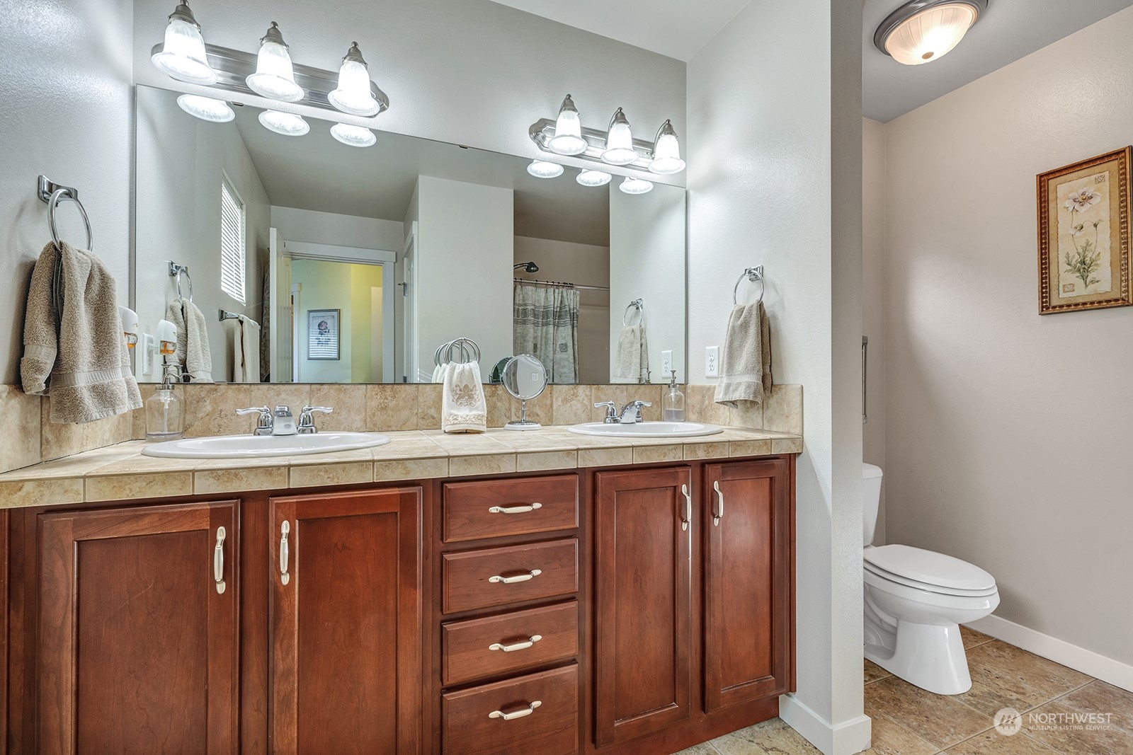 Primary bedroom bath featuring double sinks & linen closet.