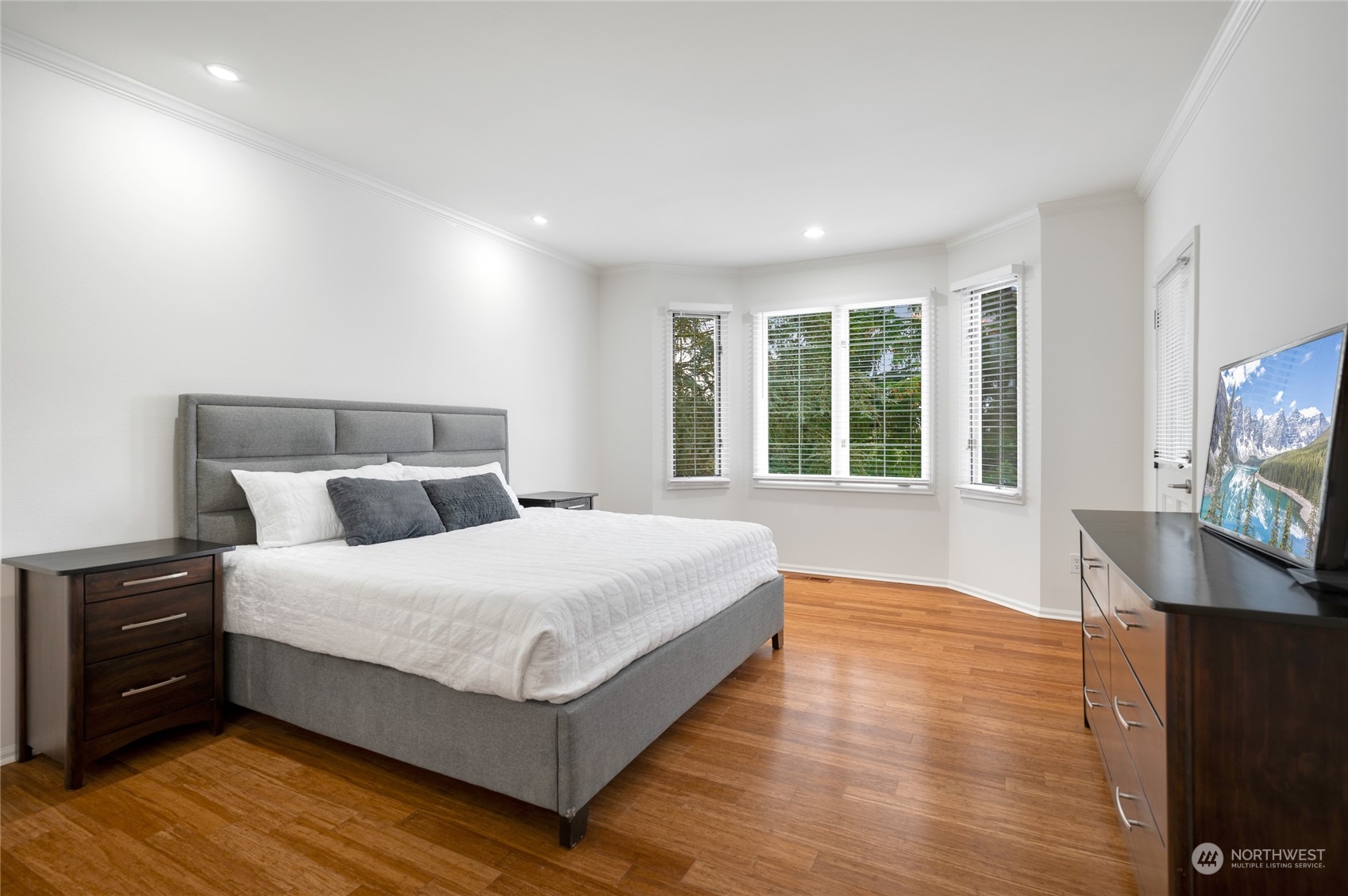 Primary bedroom is large enough for an additional sitting area and has a door that opens to the deck.